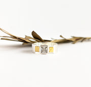A square zircon gemstone ring with hammered sterling silver links and a wide plain brass band.