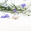 A sterling silver ring with a square amethyst stone.