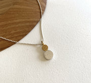 This little ‘double dot’ pendant is a play on size, colour and detail. Made from 925 sterling silver, the pendant has a gold vermeil highlight at top. Both dots have tiny dash lines decorating their matt finish surfaces
