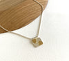 A silver square pendant necklace with gold plating and incised dashes on adjustable silver chain